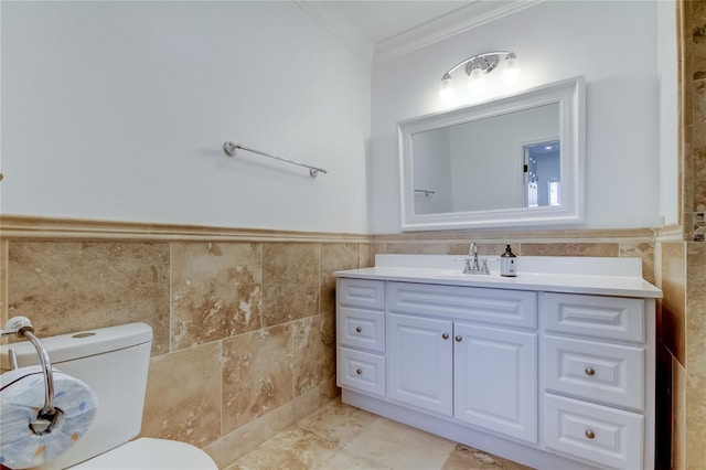 1089 Virginia St, Dunedin, FL 34698 - bathroom featuring tile walls, ornamental molding, vanity, toilet, and a wainscoted wall