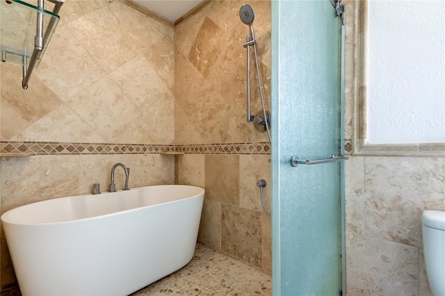 1089 Virginia St, Dunedin, FL 34698 - bathroom featuring tile walls, a soaking tub, a tile shower, and toilet