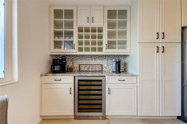 1089 Virginia St, Dunedin, FL 34698 - indoor dry bar with wine cooler, decorative backsplash, and baseboards
