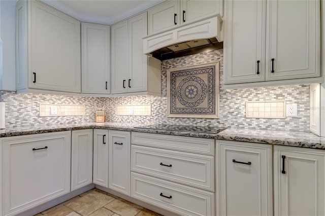 1089 Virginia St, Dunedin, FL 34698 - kitchen featuring custom exhaust hood, black electric cooktop, tasteful backsplash, and light stone counters