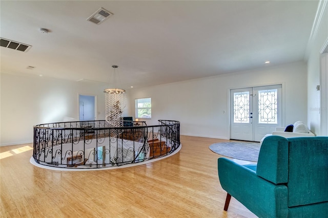 1089 Virginia St, Dunedin, FL 34698 - stairs featuring a chandelier, wood finished floors, baseboards, crown molding, and recessed lighting