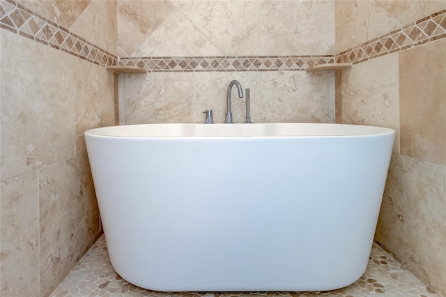 1089 Virginia St, Dunedin, FL 34698 - bathroom featuring a freestanding tub and tile walls