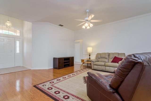 2214 Deerbrook Dr, Lakeland, FL 33811 - living room featuring wood finished floors, ceiling fan, crown molding, and baseboards