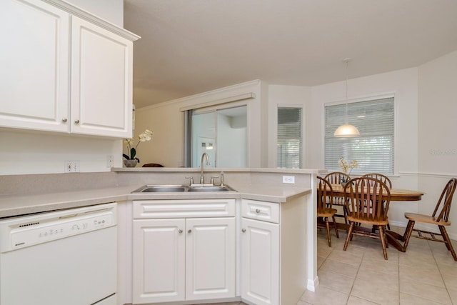 2214 Deerbrook Dr, Lakeland, FL 33811 - kitchen featuring dishwasher, a sink, a peninsula, light tile patterned floors, and light countertops