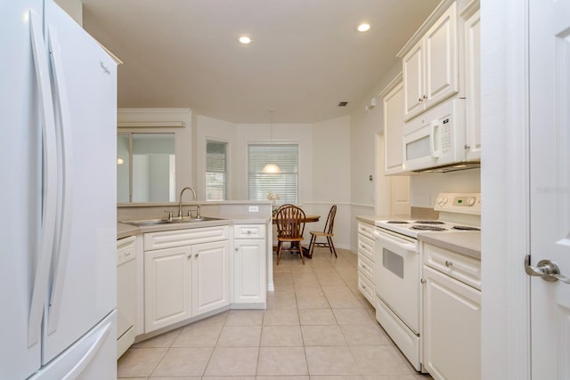 2214 Deerbrook Dr, Lakeland, FL 33811 - kitchen featuring white appliances, a sink, light countertops, light tile patterned floors, and white cabinets