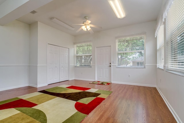 2214 Deerbrook Dr, Lakeland, FL 33811 - unfurnished bedroom featuring wood finished floors, baseboards, and ceiling fan