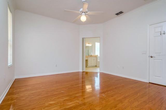 2214 Deerbrook Dr, Lakeland, FL 33811 - unfurnished bedroom featuring light wood-style floors, multiple windows, baseboards, crown molding, and ceiling fan