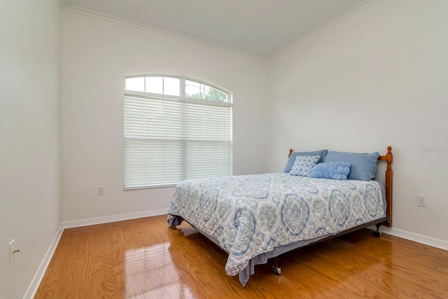 2214 Deerbrook Dr, Lakeland, FL 33811 - bedroom featuring light wood-type flooring, baseboards, and crown molding
