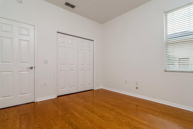 2214 Deerbrook Dr, Lakeland, FL 33811 - unfurnished bedroom with light wood-style flooring, baseboards, and multiple windows