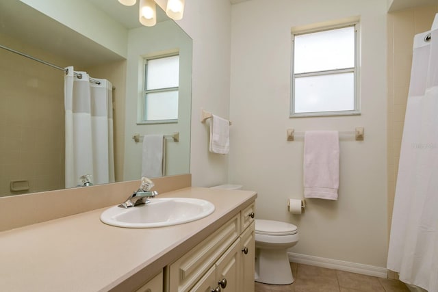 2214 Deerbrook Dr, Lakeland, FL 33811 - full bath with toilet, tile patterned flooring, curtained shower, vanity, and baseboards