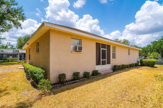 2214 Deerbrook Dr, Lakeland, FL 33811 - view of home's exterior featuring stucco siding and a yard