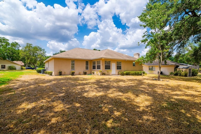 2214 Deerbrook Dr, Lakeland, FL 33811 - rear view of house featuring a chimney and stucco siding