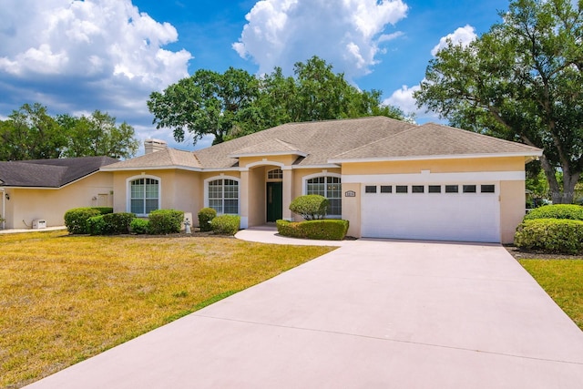 2214 Deerbrook Dr, Lakeland, FL 33811 - ranch-style house featuring stucco siding, concrete driveway, an attached garage, a front lawn, and a chimney