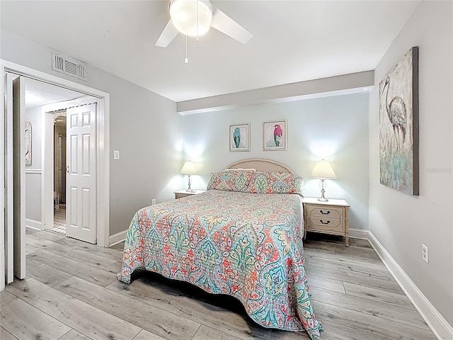 bedroom featuring wood finished floors, baseboards, and ceiling fan