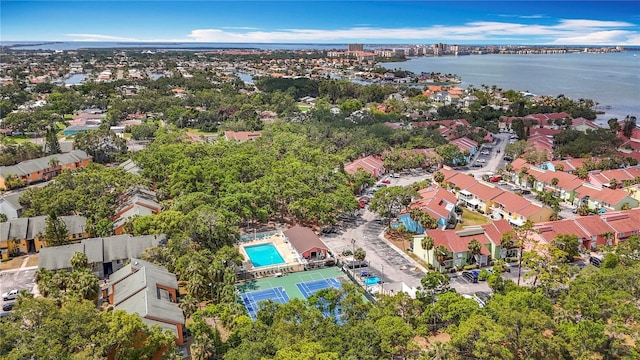 aerial overview of property's location featuring a nearby body of water and a pool