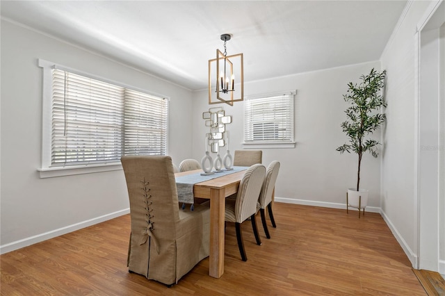 39542 Friends Ave, Zephyrhills, FL 33540 - dining area featuring a chandelier, wood finished floors, and ornamental molding