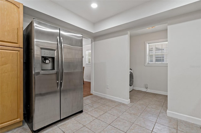39542 Friends Ave, Zephyrhills, FL 33540 - kitchen with stainless steel fridge, washer / clothes dryer, light tile patterned flooring, healthy amount of natural light, and recessed lighting