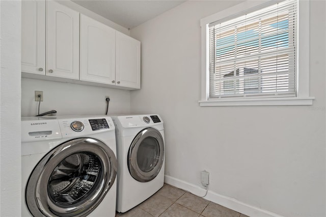 39542 Friends Ave, Zephyrhills, FL 33540 - washroom with washer and dryer, cabinet space, and light tile patterned flooring