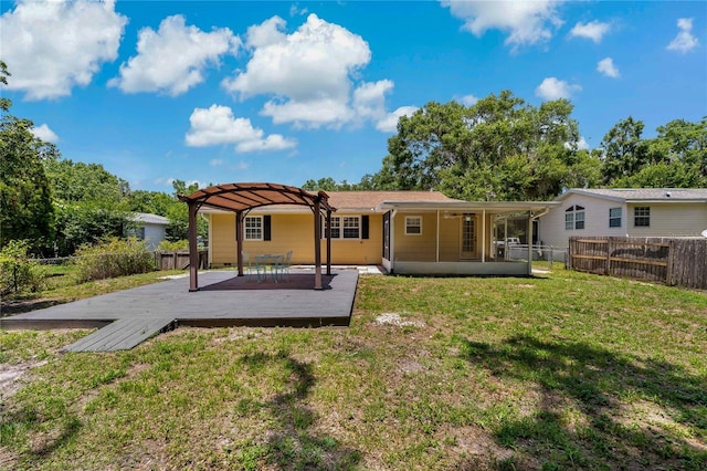 39542 Friends Ave, Zephyrhills, FL 33540 - back of property with a fenced backyard, a wooden deck, and a pergola