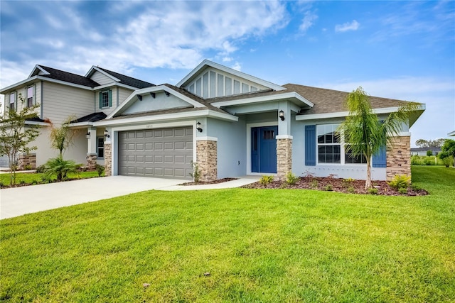 craftsman-style house with a garage, concrete driveway, a front lawn, stone siding, and stucco siding