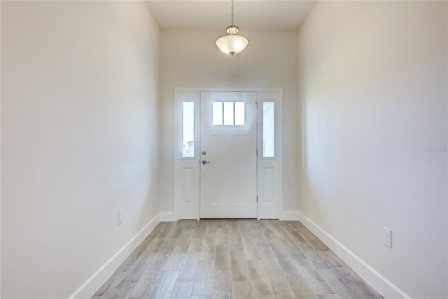 foyer entrance featuring light wood-type flooring and baseboards