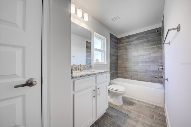 full bath featuring toilet, vanity, washtub / shower combination, and wood tiled floors