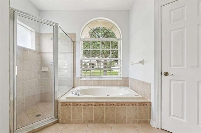 full bathroom with a garden tub, a shower stall, and tile patterned floors