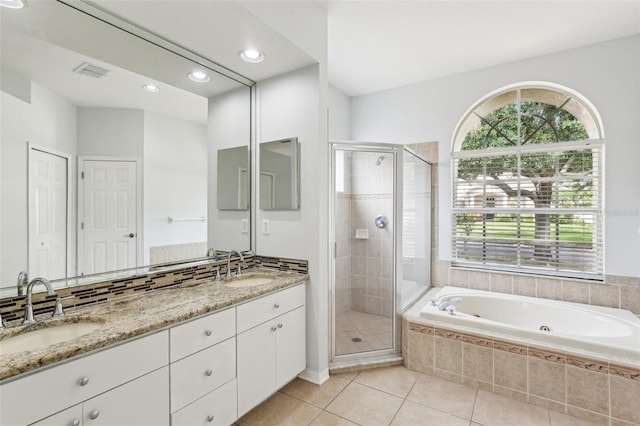 full bathroom featuring a stall shower, tile patterned flooring, a whirlpool tub, double vanity, and recessed lighting
