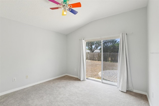 carpeted empty room featuring lofted ceiling, a ceiling fan, and baseboards
