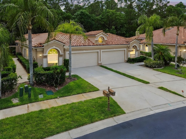 3762 Darston St, Palm Harbor, FL 34685 - mediterranean / spanish-style home with stucco siding, an attached garage, a tiled roof, concrete driveway, and a front yard
