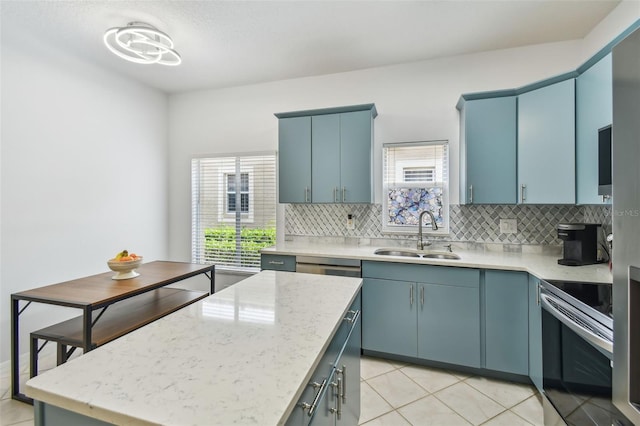 3762 Darston St, Palm Harbor, FL 34685 - kitchen with a sink, electric stove, blue cabinets, and decorative backsplash