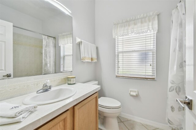 3762 Darston St, Palm Harbor, FL 34685 - full bathroom featuring toilet, tile patterned floors, vanity, and baseboards