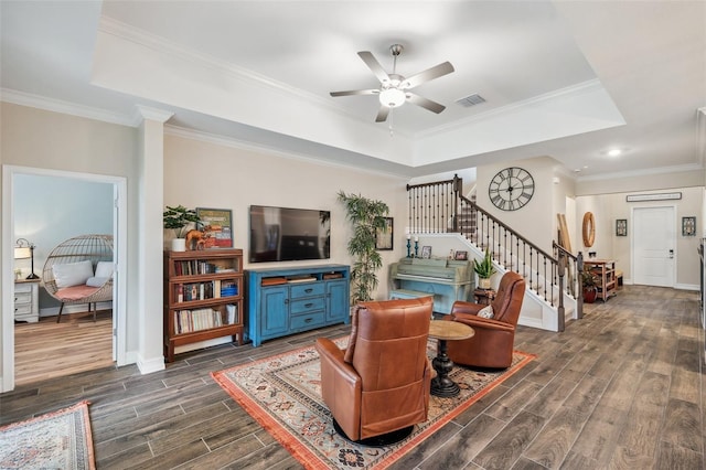 22294 Storybook Cabin Way, Land O Lakes, FL 34637 - living room with a raised ceiling, stairs, wood finish floors, ceiling fan, and ornamental molding