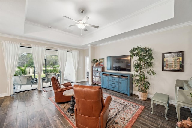 22294 Storybook Cabin Way, Land O Lakes, FL 34637 - living area featuring a raised ceiling, ceiling fan, dark wood-type flooring, baseboards, and ornamental molding