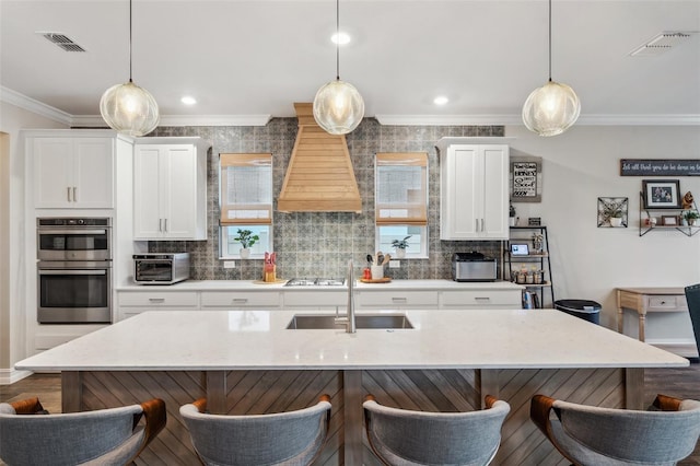 22294 Storybook Cabin Way, Land O Lakes, FL 34637 - kitchen with ornamental molding, a sink, a breakfast bar, and tasteful backsplash