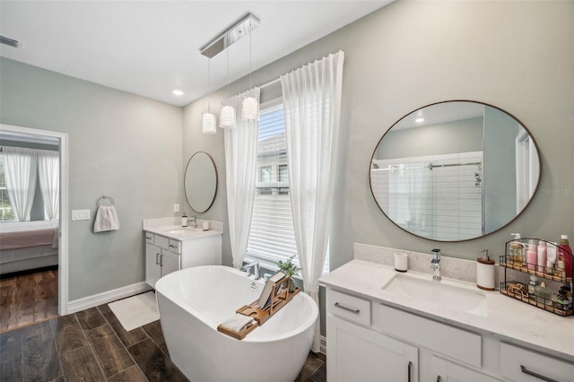 22294 Storybook Cabin Way, Land O Lakes, FL 34637 - ensuite bathroom featuring wood finished floors, a freestanding bath, tiled shower, baseboards, and recessed lighting