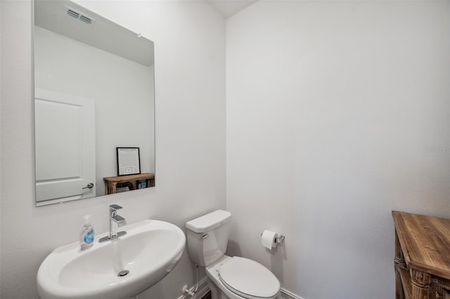 22294 Storybook Cabin Way, Land O Lakes, FL 34637 - bathroom with a sink, toilet, and baseboards