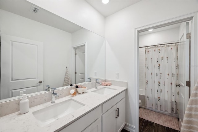22294 Storybook Cabin Way, Land O Lakes, FL 34637 - full bath featuring toilet, double vanity, shower / bath combo, wood finished floors, and recessed lighting