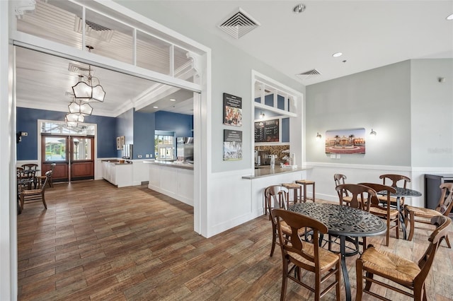 22294 Storybook Cabin Way, Land O Lakes, FL 34637 - dining space with wood finished floors, built in features, a wainscoted wall, and recessed lighting