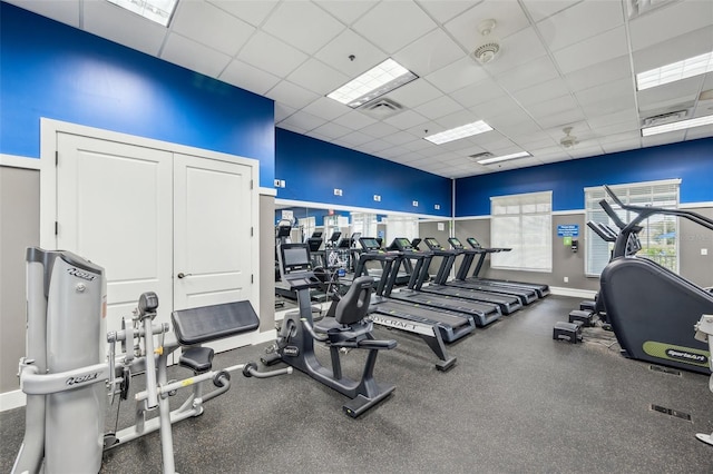 22294 Storybook Cabin Way, Land O Lakes, FL 34637 - exercise room with a paneled ceiling, baseboards, and a towering ceiling