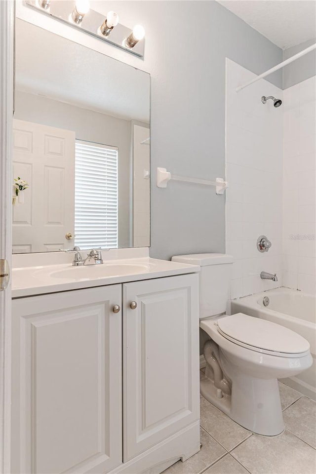 bathroom featuring tile patterned floors, vanity, toilet, and bathing tub / shower combination