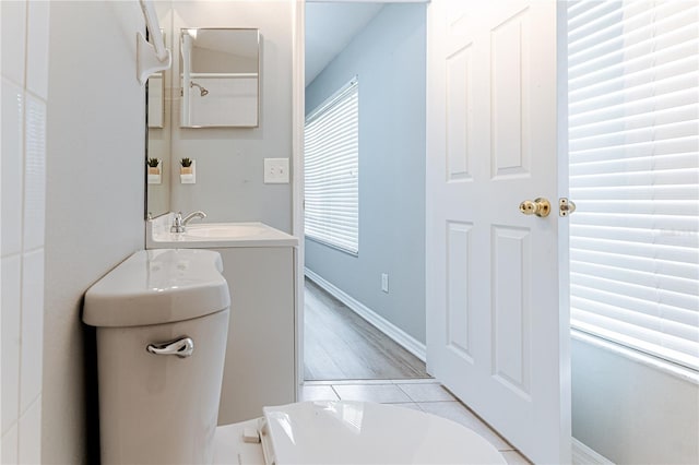 bathroom featuring tile patterned floors, a sink, baseboards, and toilet