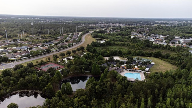 aerial view of property's location with a large body of water and nearby suburban area