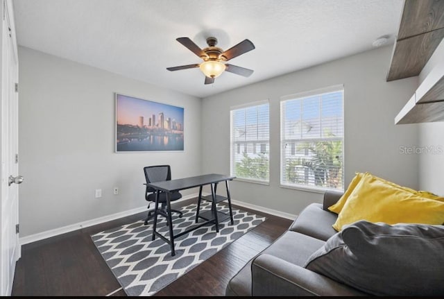 home office featuring ceiling fan, baseboards, and dark wood-style flooring