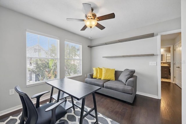 office area featuring ceiling fan, dark wood-style flooring, and baseboards
