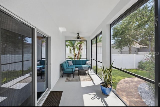 sunroom featuring outdoor lounge area and ceiling fan
