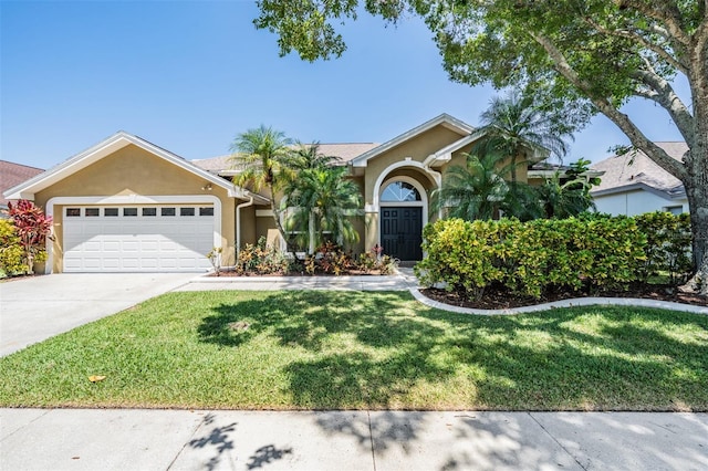 12421 Seabrook Dr, Tampa, FL 33626 - view of front of house with stucco siding, an attached garage, driveway, and a front yard