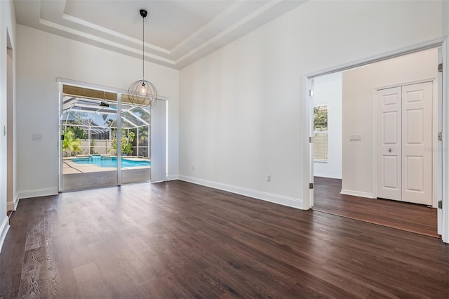 12421 Seabrook Dr, Tampa, FL 33626 - empty room with plenty of natural light, dark wood-style floors, and a raised ceiling