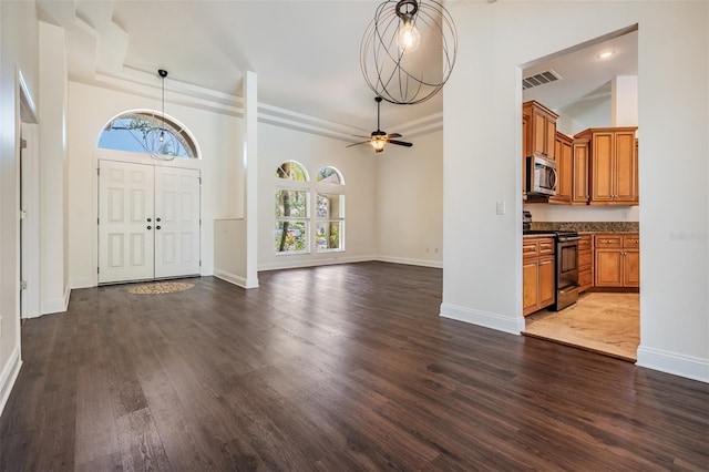 12421 Seabrook Dr, Tampa, FL 33626 - foyer featuring healthy amount of natural light, dark wood finished floors, and baseboards