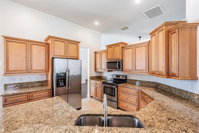 12421 Seabrook Dr, Tampa, FL 33626 - kitchen featuring appliances with stainless steel finishes, a sink, light stone counters, and recessed lighting